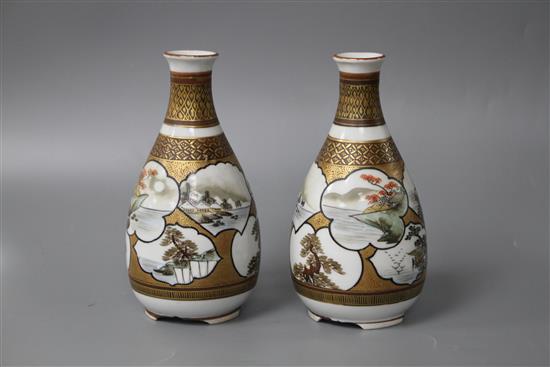 A pair of Kutani porcelain vases, decorated with landscape panels, signed to the underside, height 13.75cm